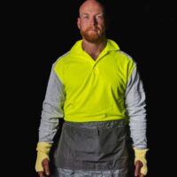 Model wearing PPE Factory polo shirt 3899 in color HiViz Yellow and apron 5070